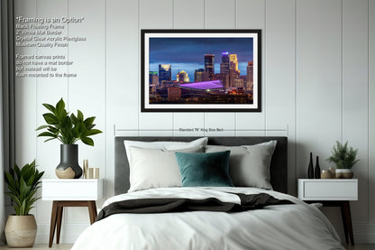 a bedroom with a bed and a picture hanging above it