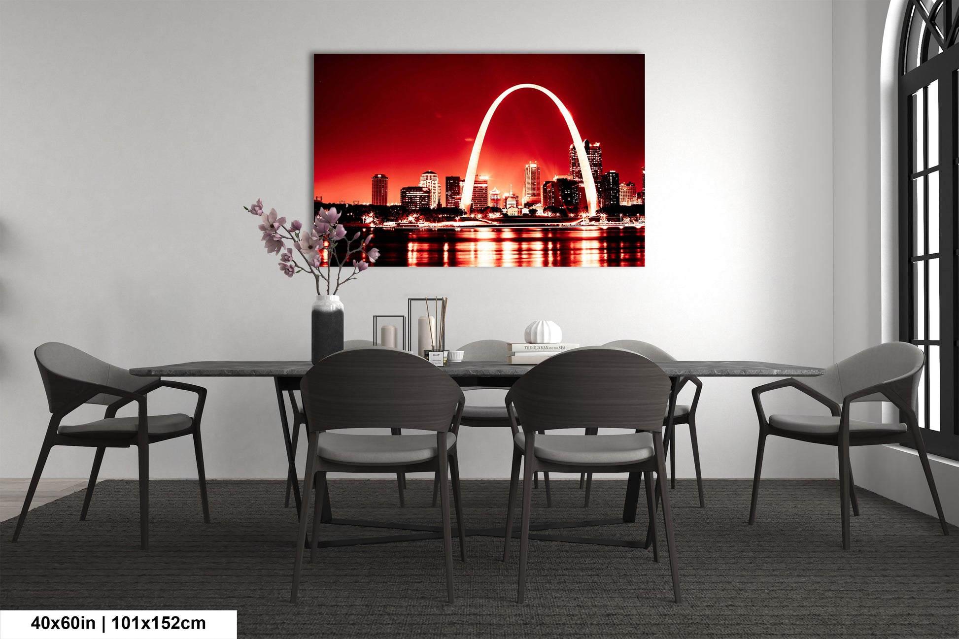 a dining room table with chairs and a picture of the st louis arch