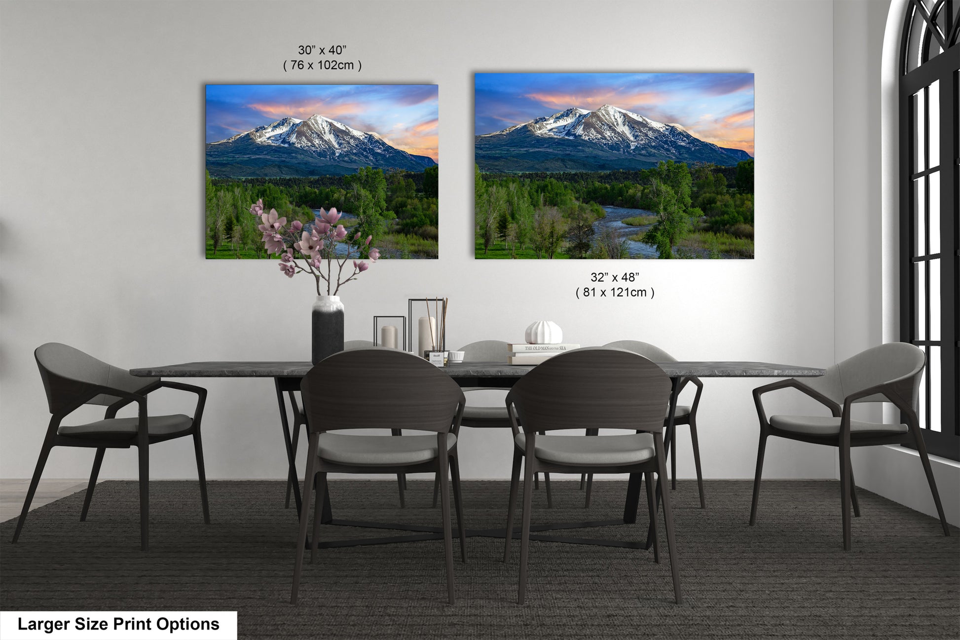 a dining room table with four chairs and a vase of flowers