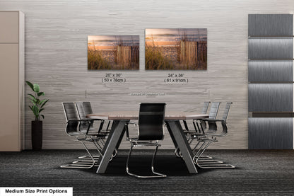 a dining room table with chairs next to a wall with pictures on it