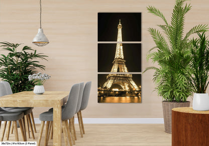 a room with a table and chairs and a picture of the eiffel tower