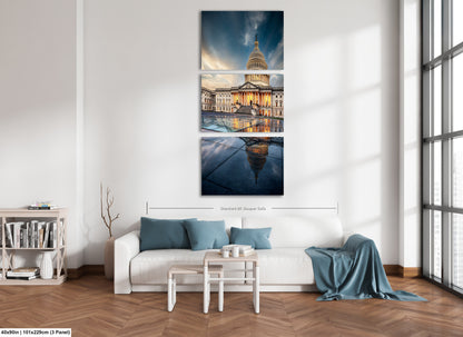 a living room with a white couch and a painting on the wall