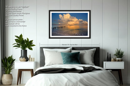 a bedroom with a bed and a picture hanging on the wall