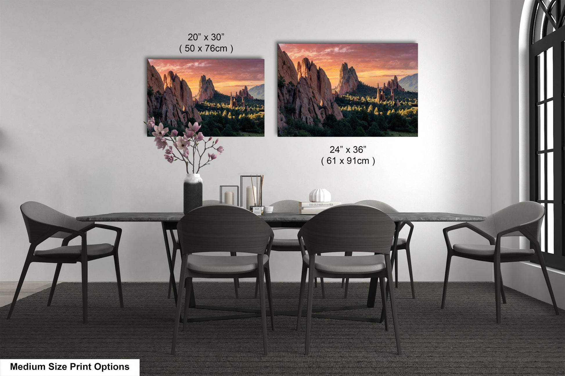 a dining room table with four chairs and a vase of flowers