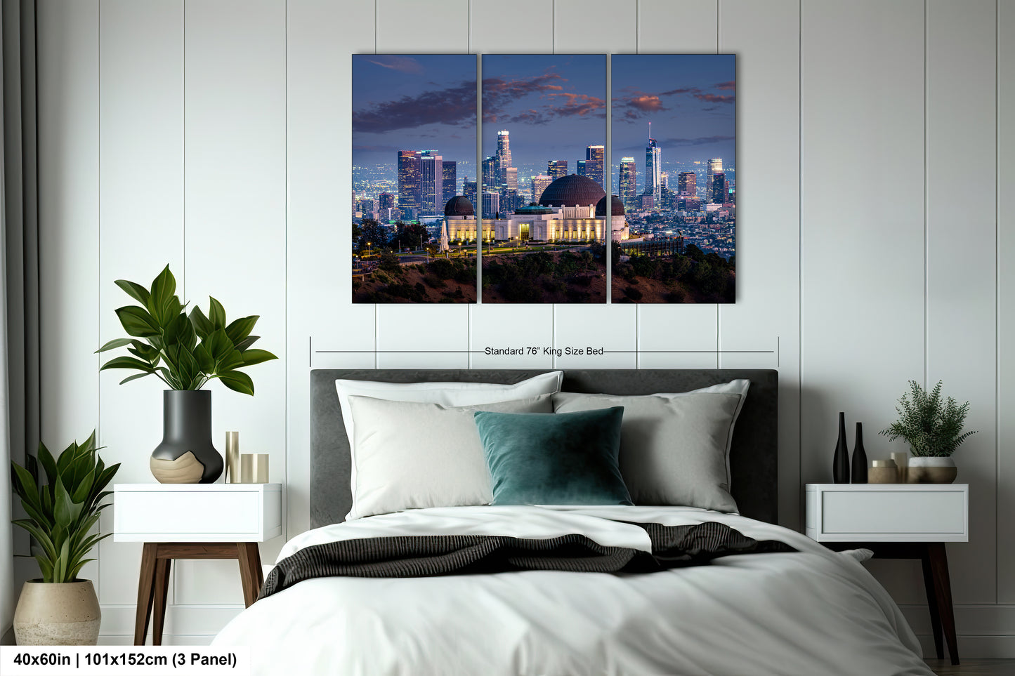 a bedroom with a large bed and a night view of a city