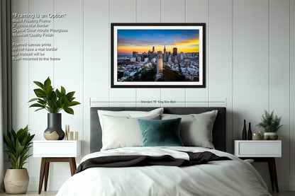 a bedroom with a picture of a city at sunset