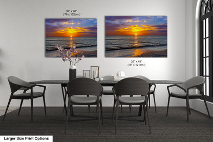a dining room table with four chairs and a vase of flowers