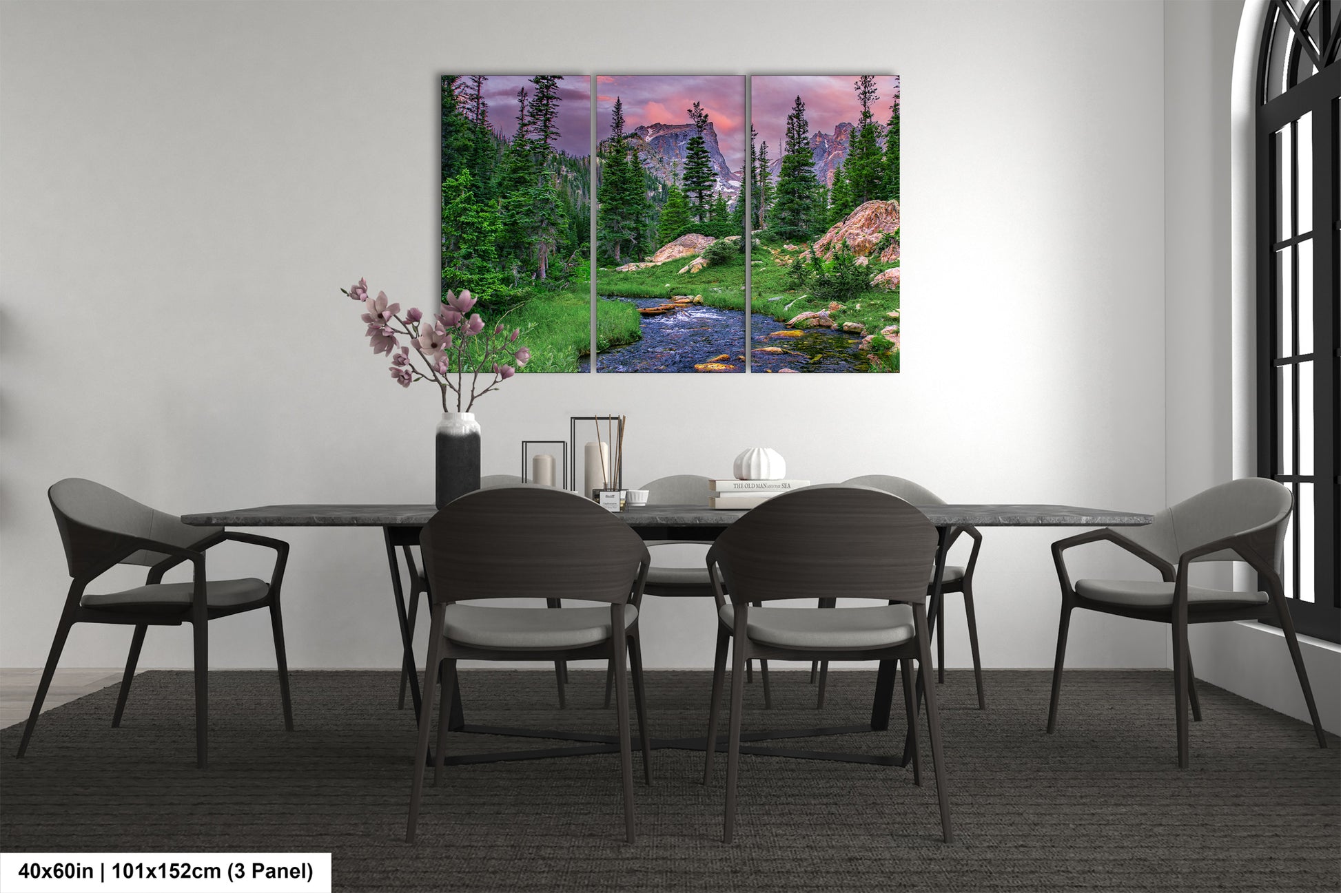 a dining room table with chairs and a painting on the wall