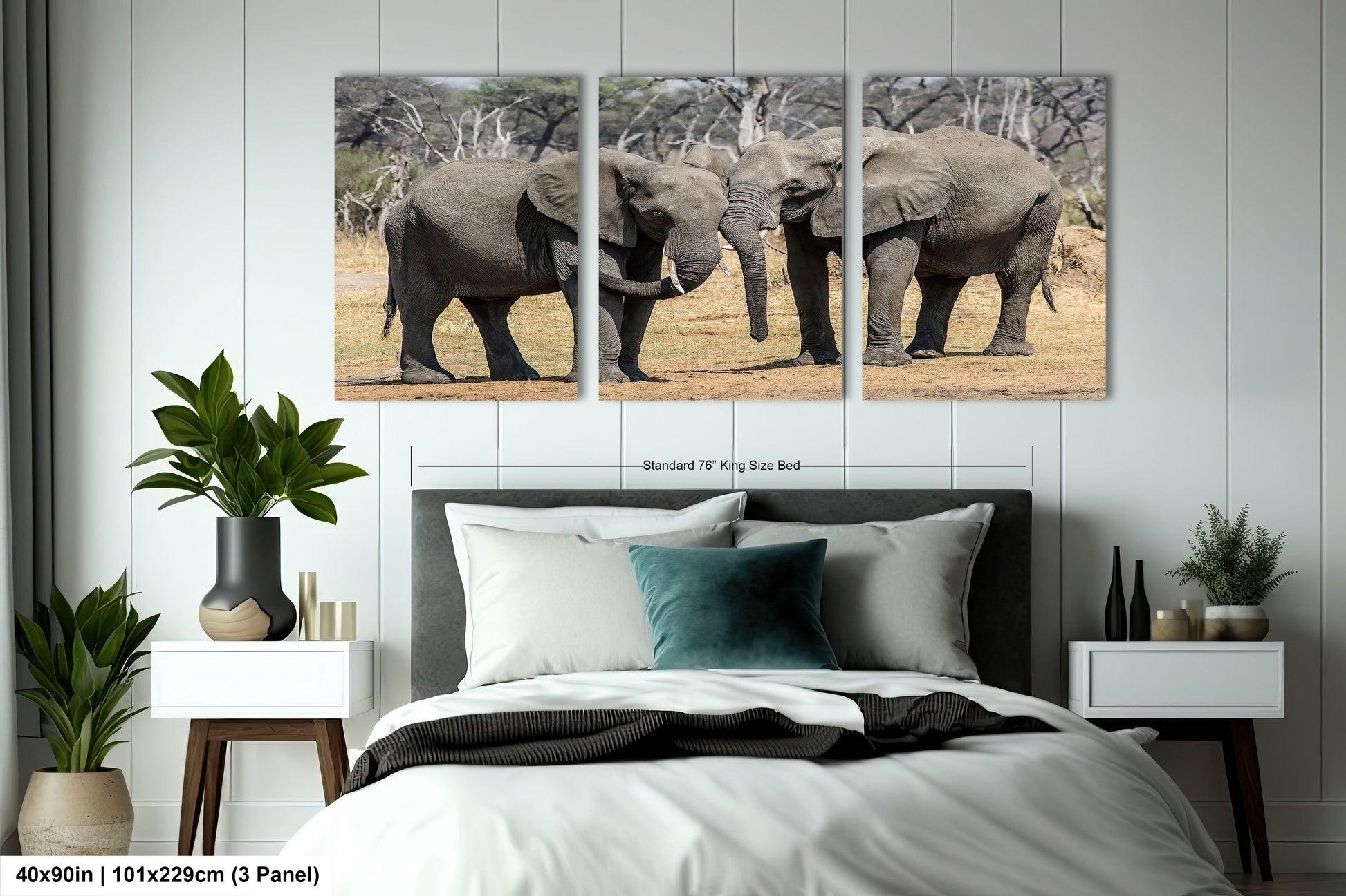 a couple of elephants standing next to each other on a bed
