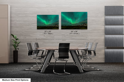 a dining room table with chairs and a picture of the northern lights