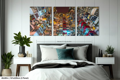a bed room with a neatly made bed and two paintings on the wall