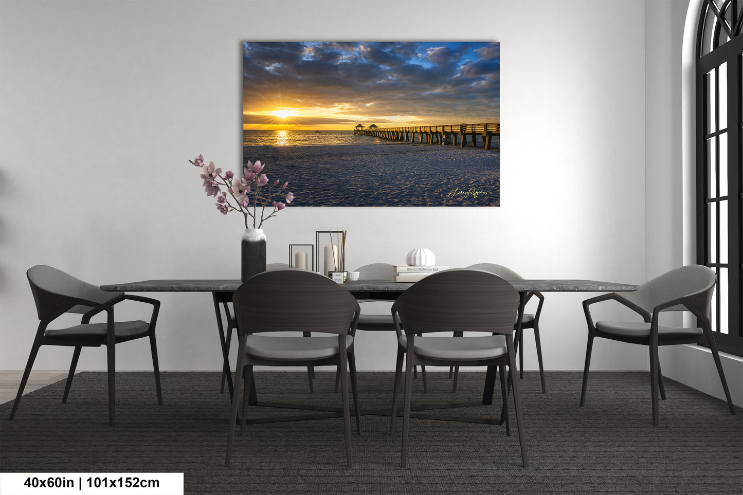 a dining room table with chairs and a painting on the wall