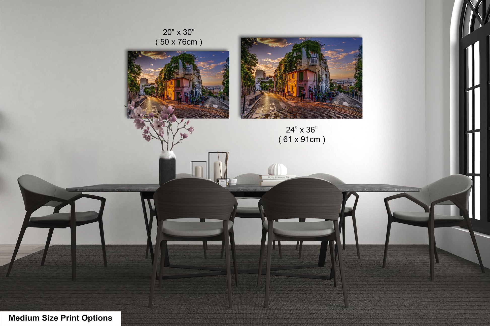 a dining table with four chairs and a vase of flowers