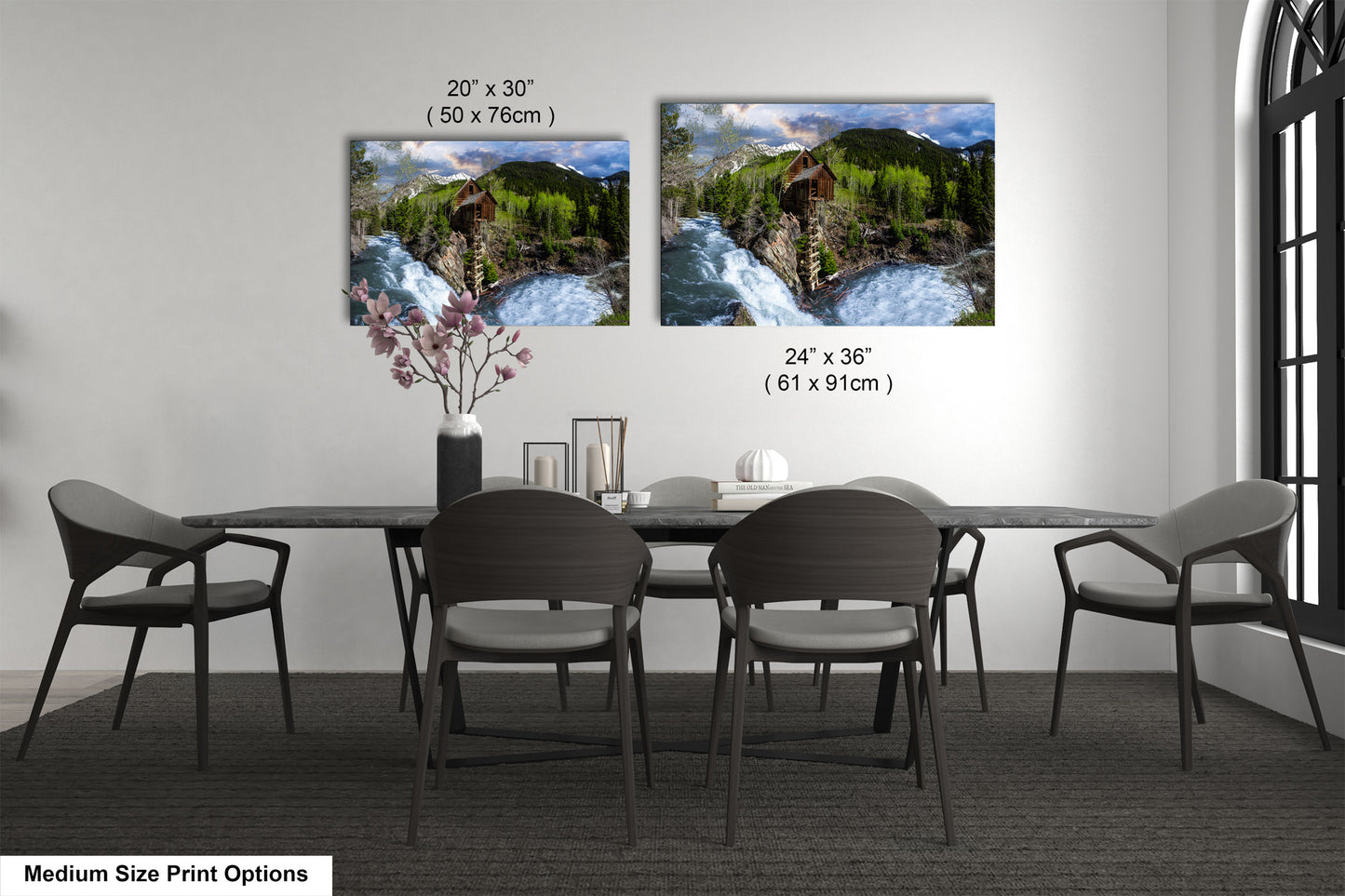 a dining room table with four chairs and a vase of flowers
