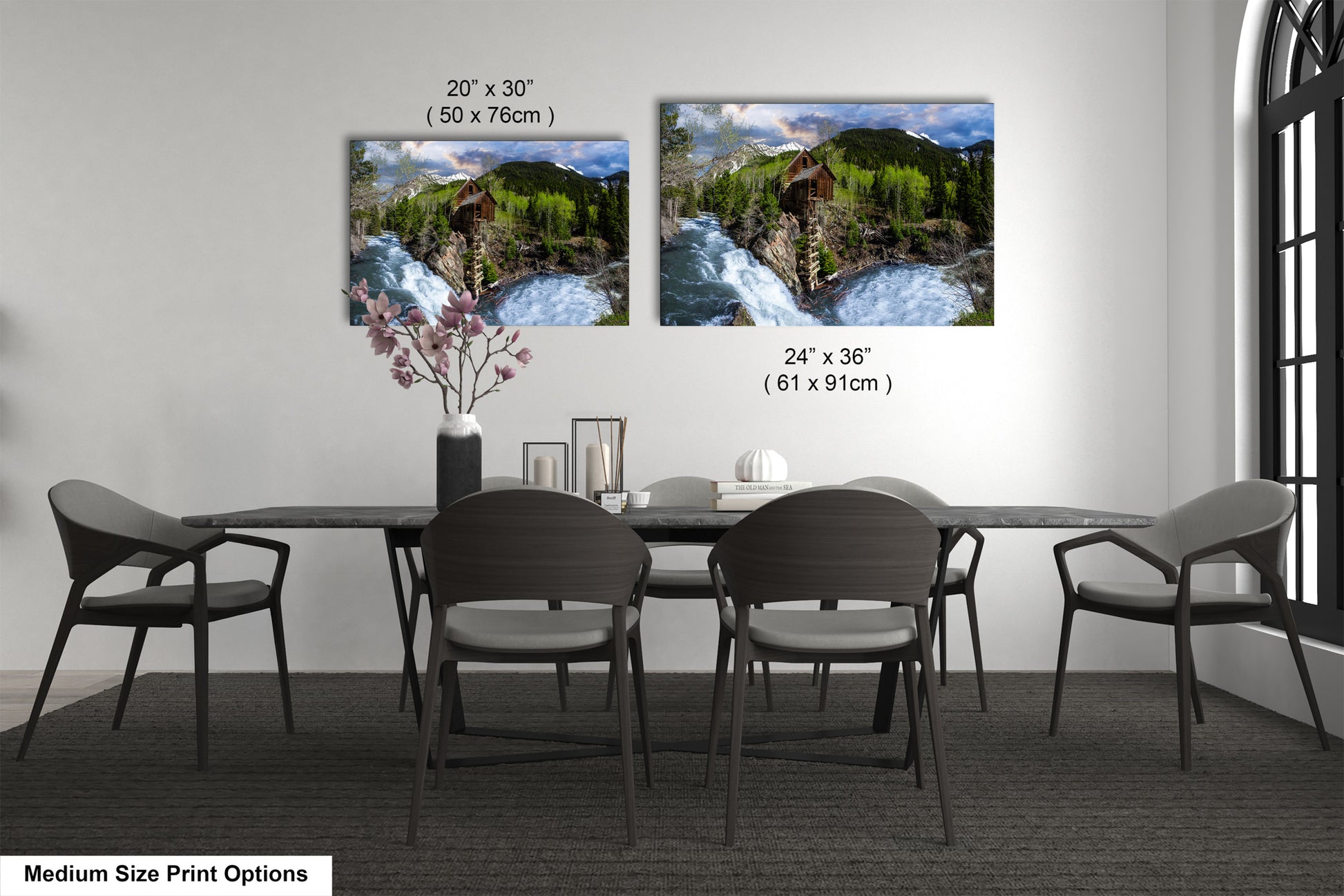 a dining room table with four chairs and a vase of flowers