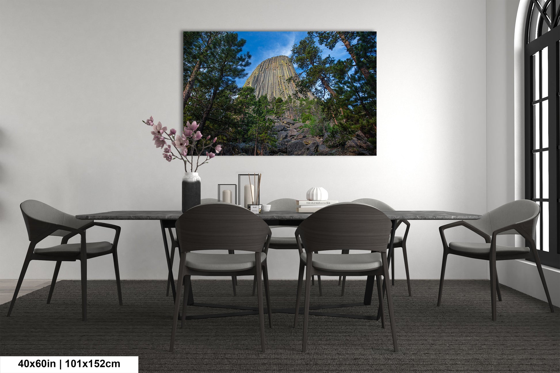a room with a table and chairs and a painting on the wall