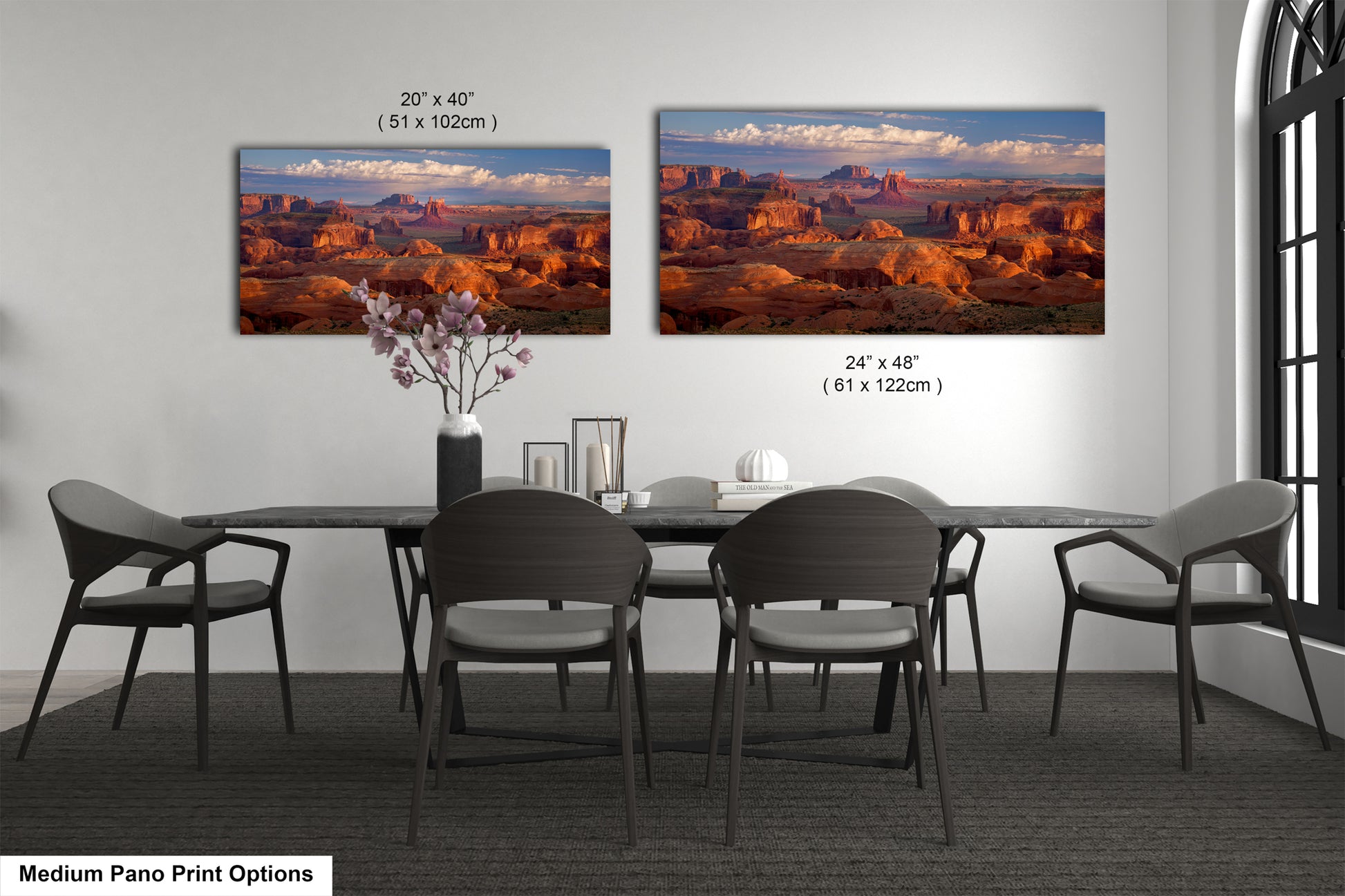 a dining room table with four chairs and a vase of flowers
