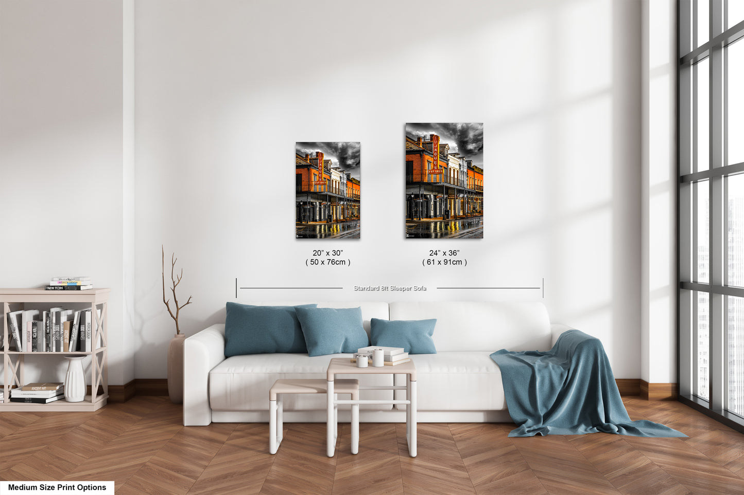 a living room with a white couch and two pictures on the wall