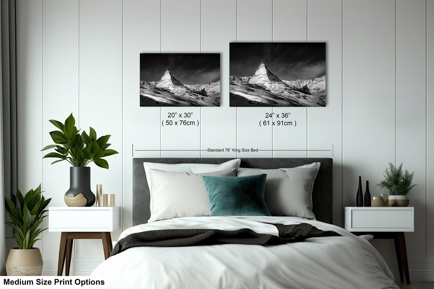 a bed with two pictures on the wall above it