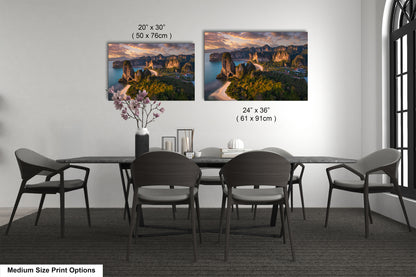 a dining table with four chairs and a vase of flowers