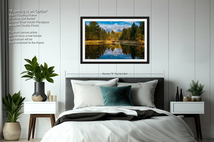 a bedroom with a bed and a picture hanging on the wall