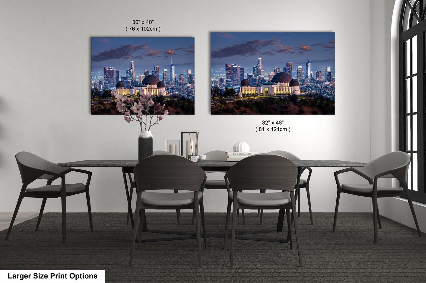 a dining room table with four chairs and a vase of flowers