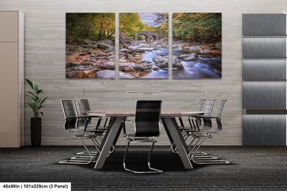 a dining room table with chairs and a painting on the wall