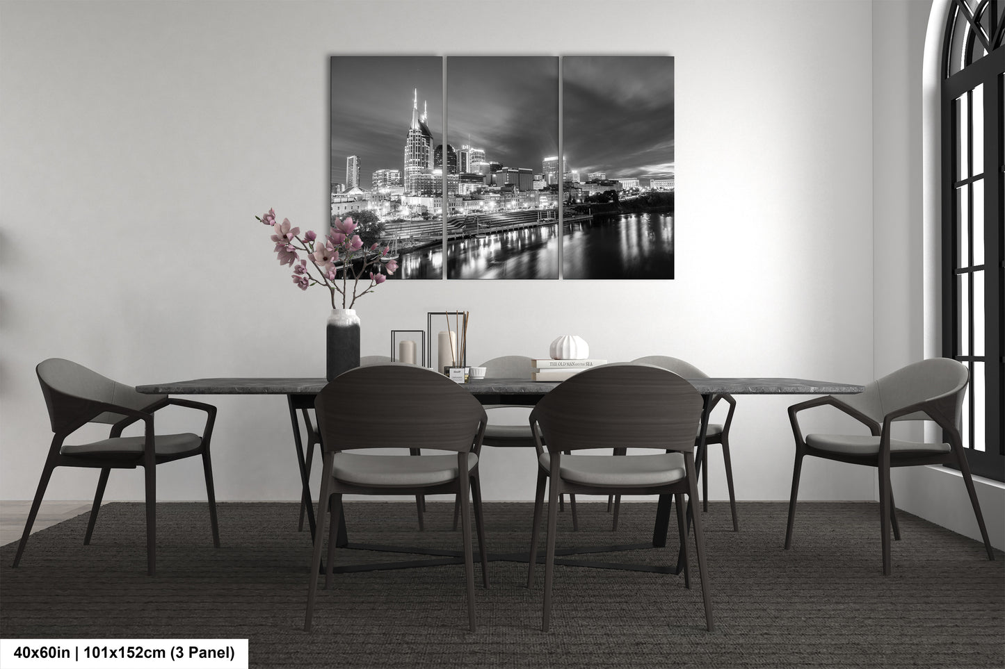 a black and white photo of a dining room table