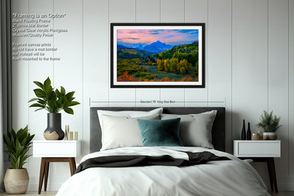 a bedroom with a large bed and a painting on the wall
