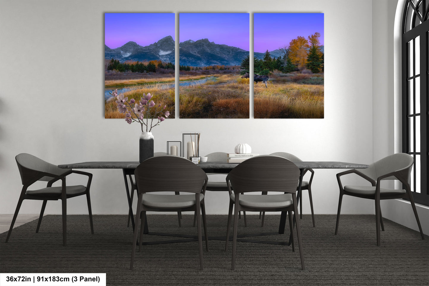 a dining room table with chairs and a painting on the wall