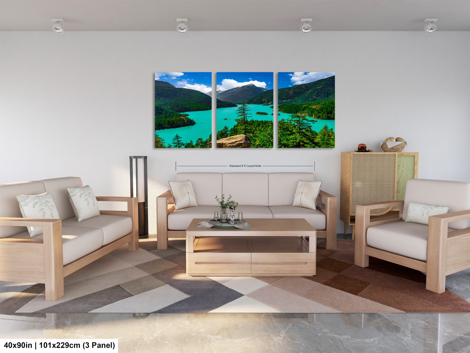 The image is a modern living room with a large, three-panel landscape painting hanging on the wall. The painting depicts a scenic mountain landscape with a turquoise lake and lush green forests. The room is furnished with a sofa, two armchairs, and a coffee table, creating a comfortable and inviting atmosphere.