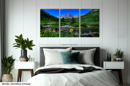 a bed room with a neatly made bed and a painting on the wall