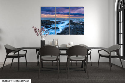a dining room table with chairs and a painting on the wall