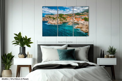a bed room with a neatly made bed and a painting on the wall