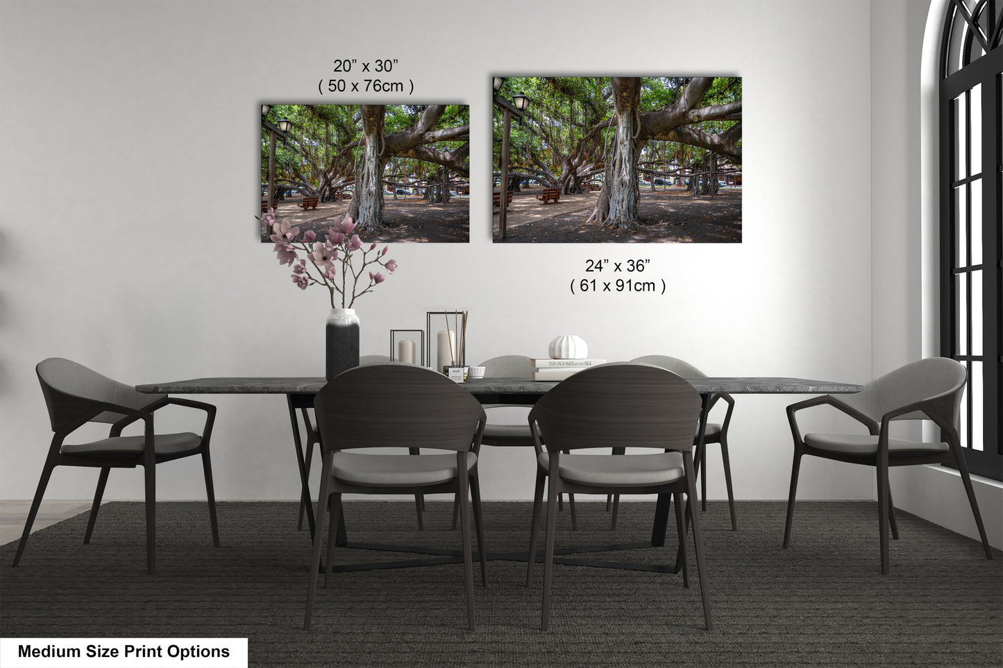 a dining table with four chairs and a vase of flowers