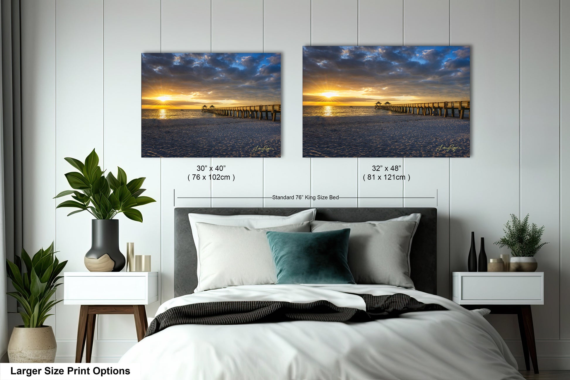 a bed with two pictures on the wall above it
