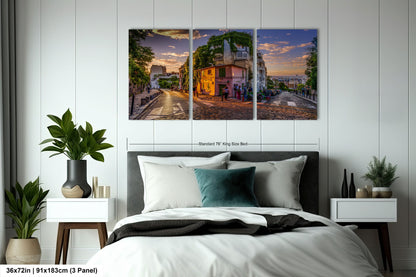 a bedroom with a bed and two paintings on the wall