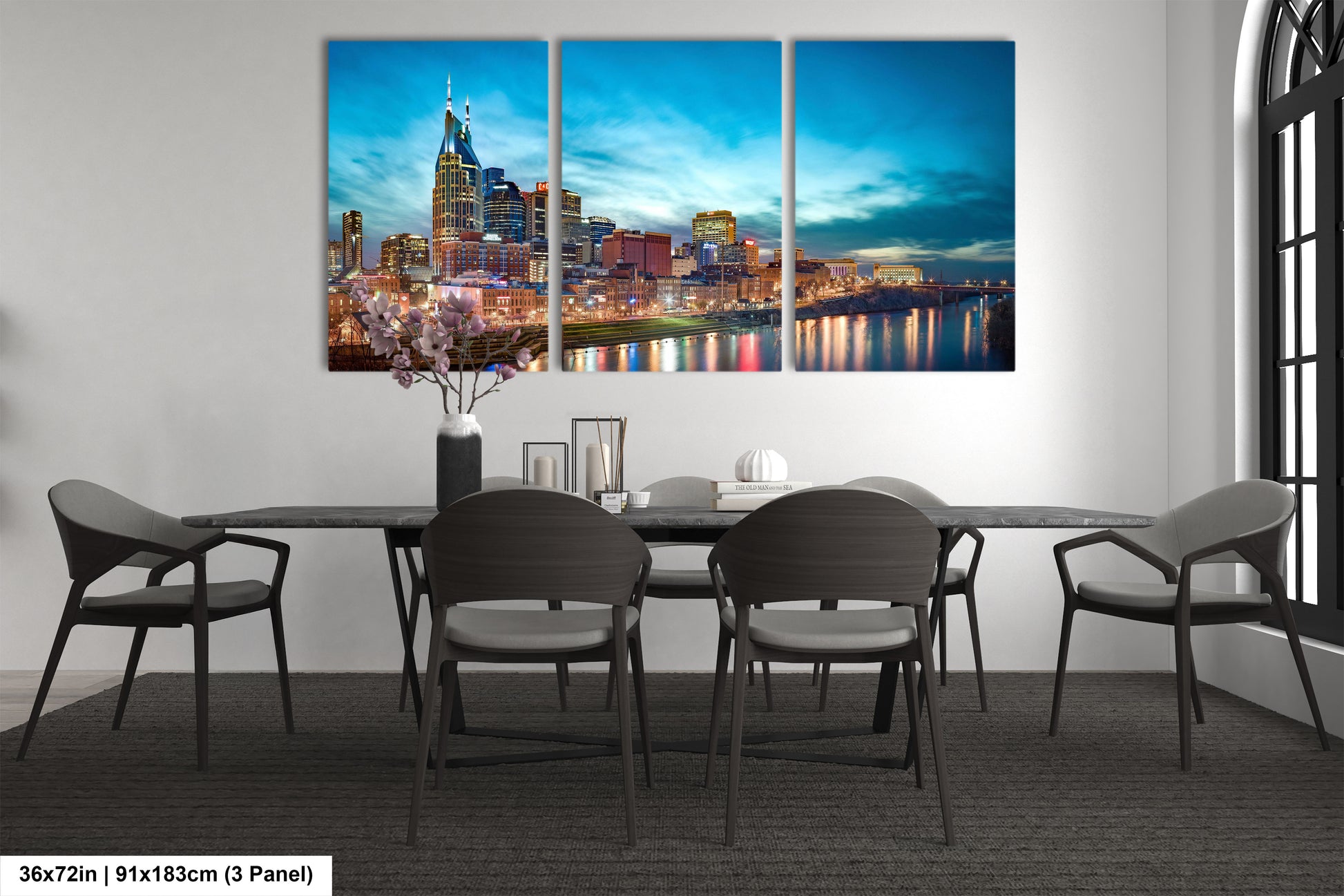 a dining room table with chairs and a painting on the wall