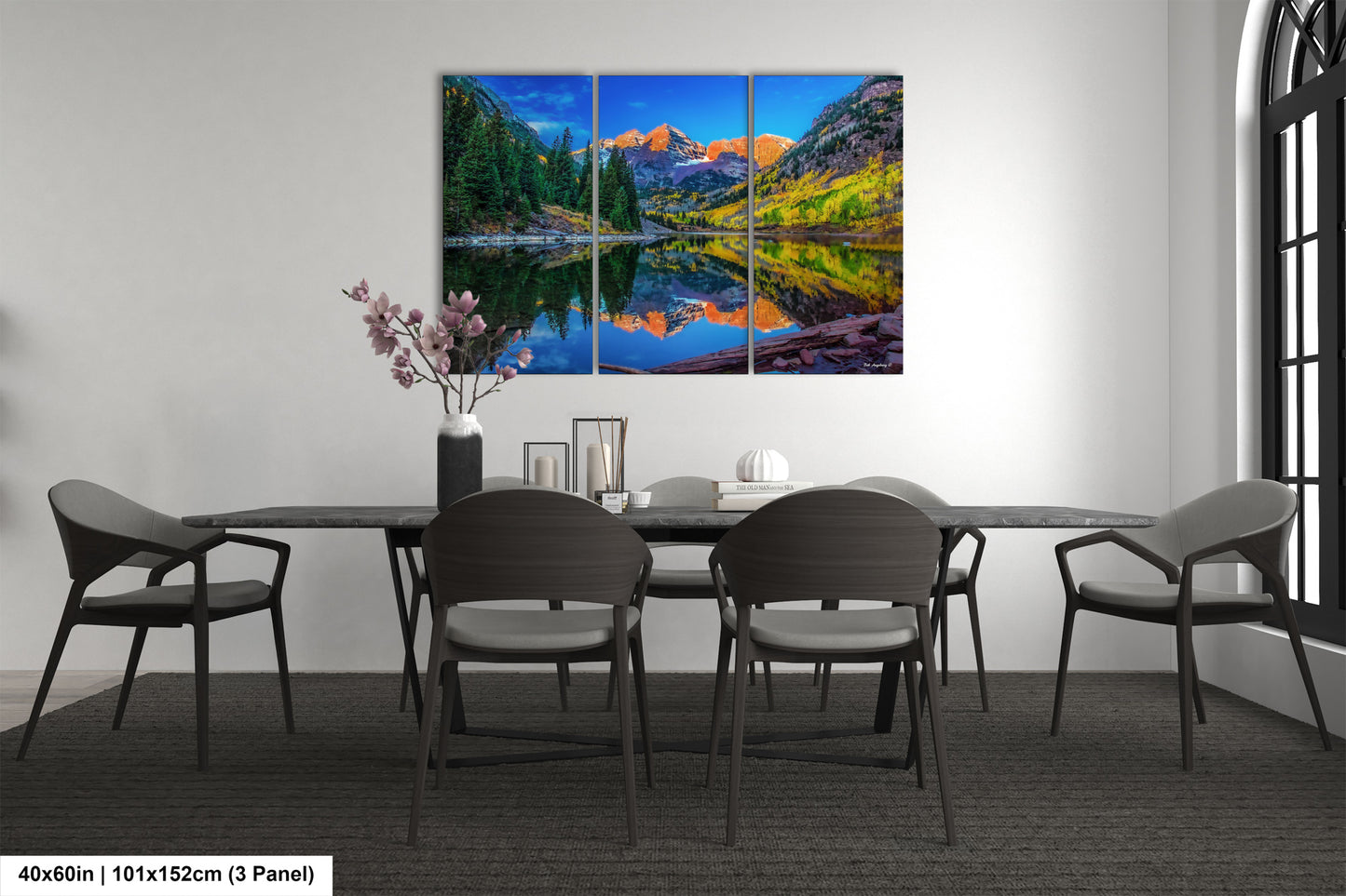 a dining room table with chairs and a painting on the wall