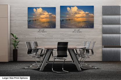 a dining room table with chairs and two pictures on the wall
