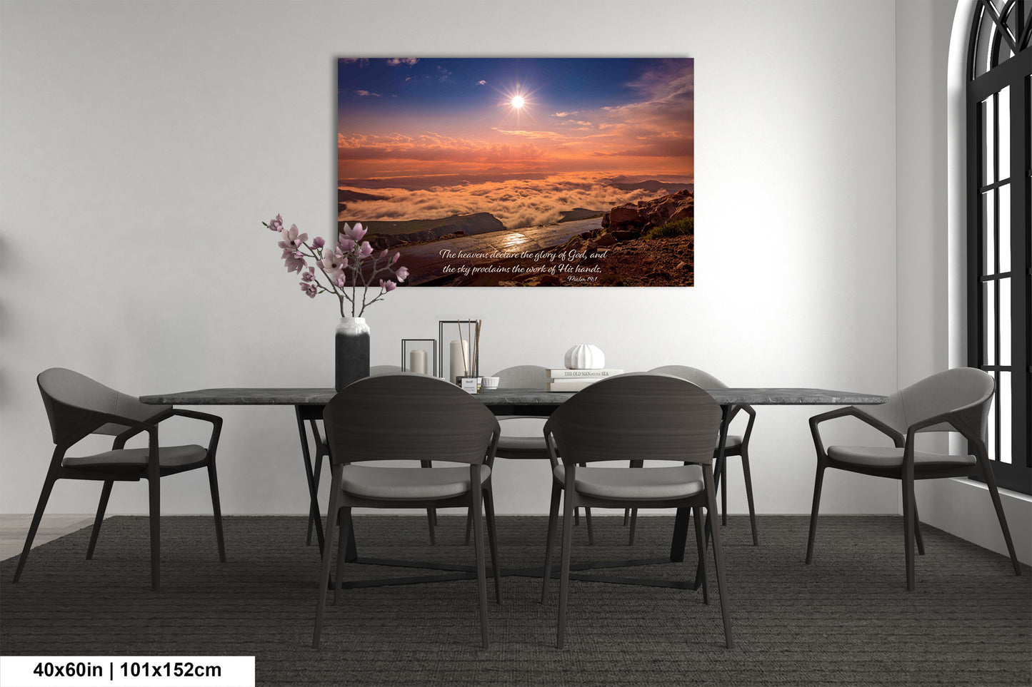a dining room table with chairs and a painting on the wall