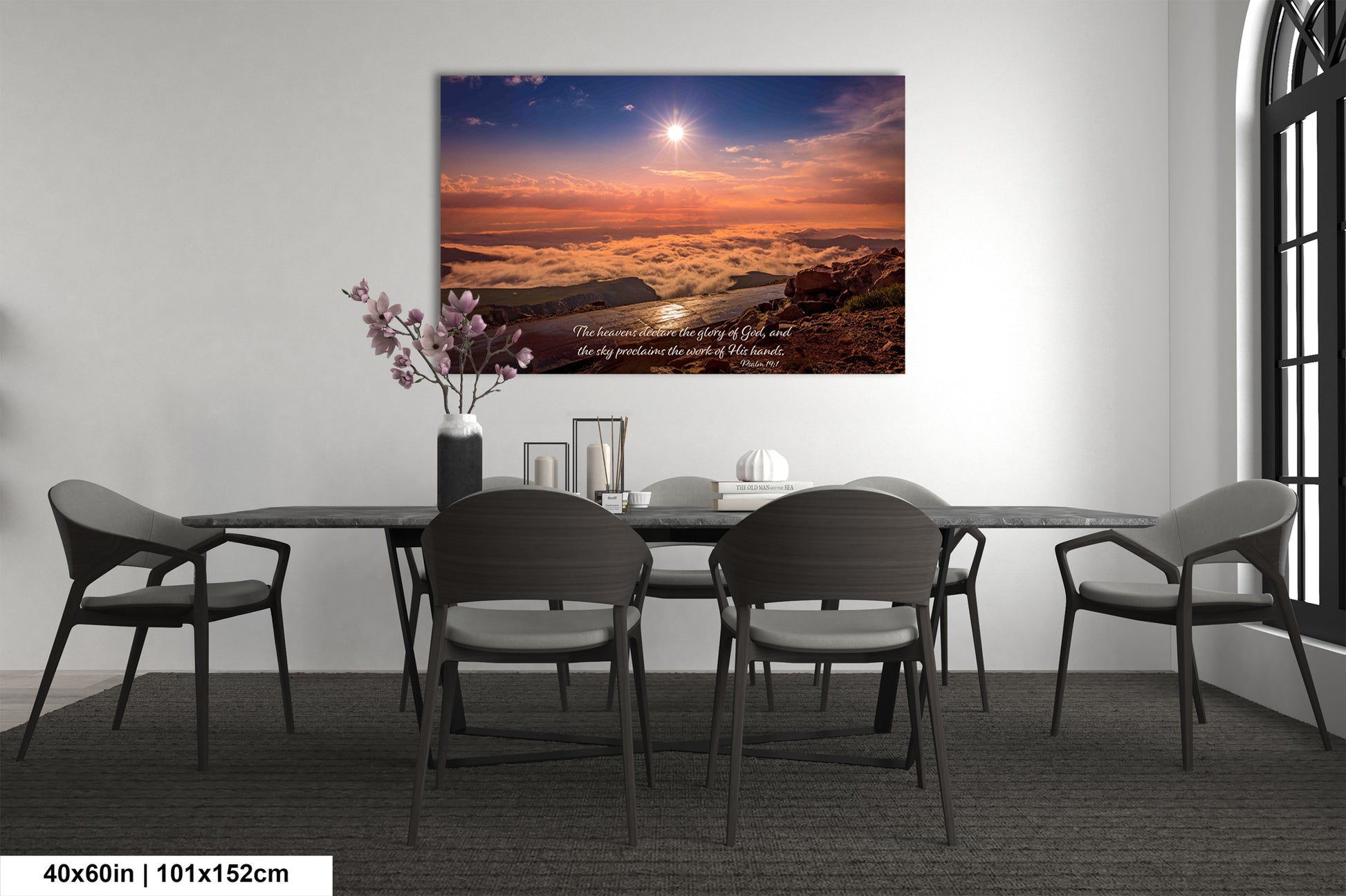 a dining room table with chairs and a painting on the wall