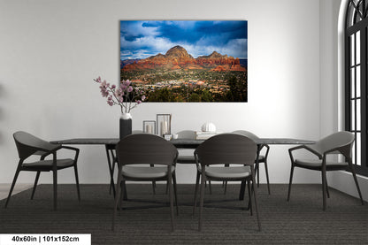 a dining room table with chairs and a painting on the wall