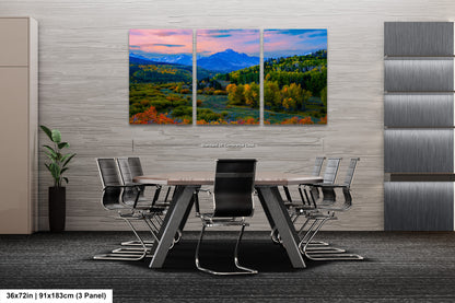 a dining room table with chairs and a painting on the wall