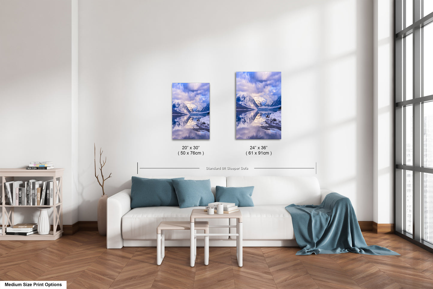 a living room with a white couch and two paintings on the wall