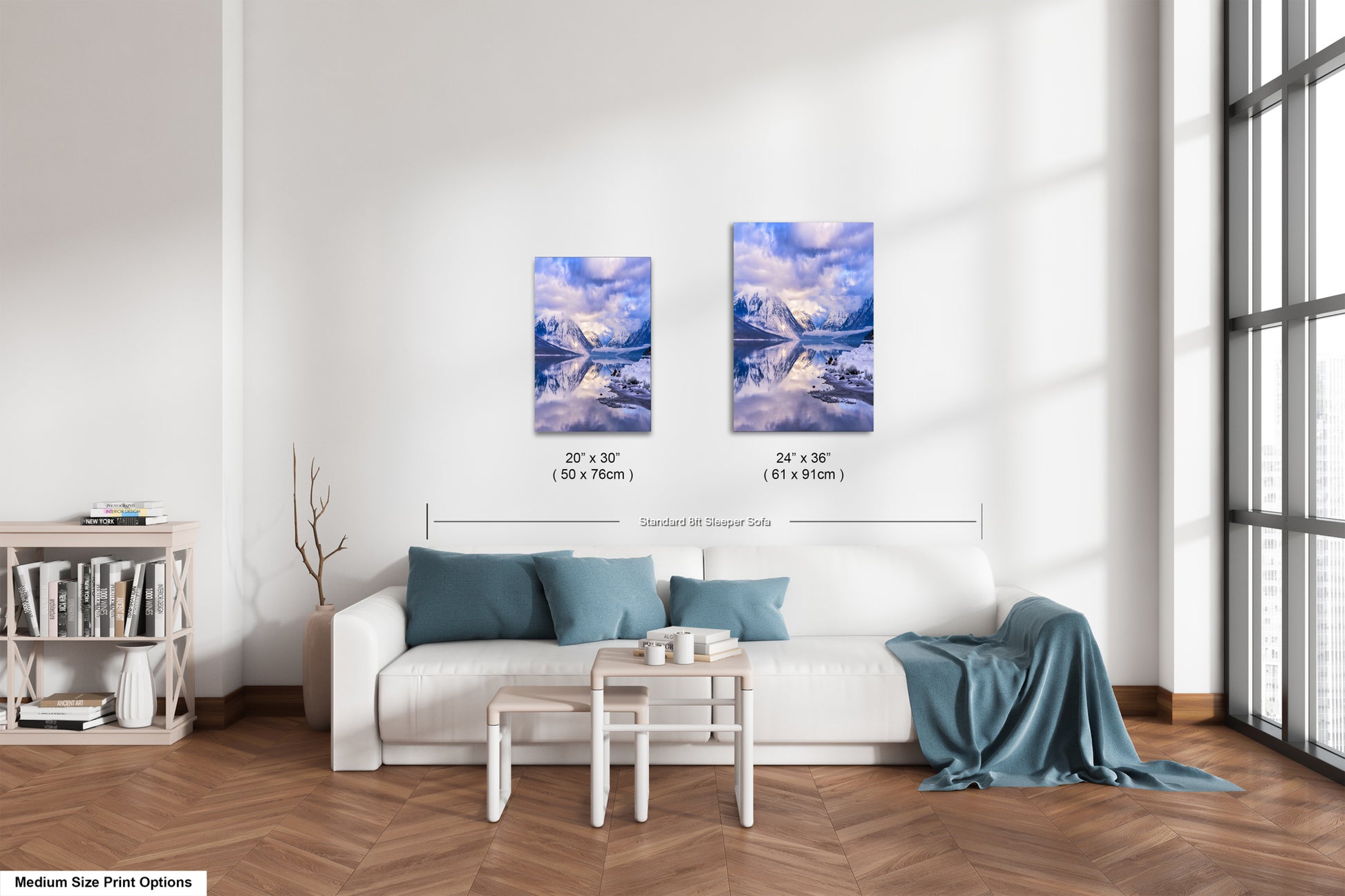 a living room with a white couch and two paintings on the wall