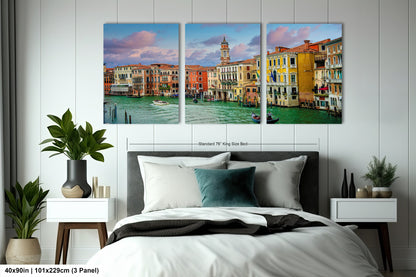 a bedroom with a large bed and three paintings on the wall