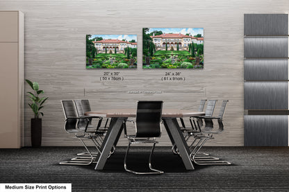 a dining room table with chairs and two pictures on the wall
