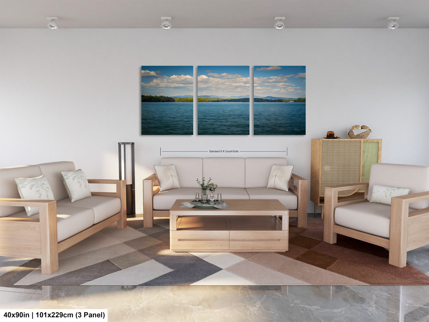 The image is a modern living room with a large, three-panel landscape painting hanging on the wall. The painting depicts a serene body of water with a blue sky and fluffy clouds. The room is furnished with a sofa, two armchairs, and a coffee table, creating a comfortable and inviting atmosphere.