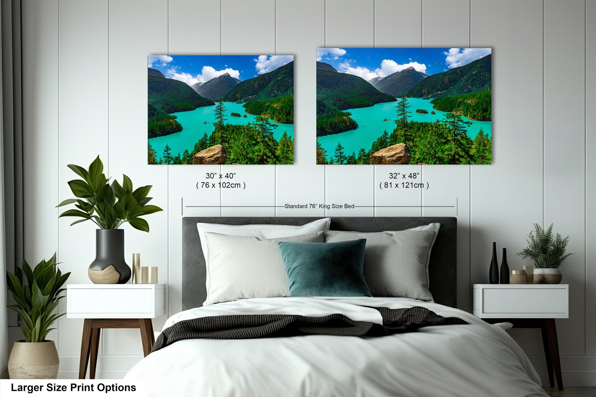 a bedroom with two framed landscape photographs hanging on the wall above a bed. The photographs depict a scenic mountain landscape with a turquoise lake and lush green forests. The wall is painted white, and the bed has a black headboard. There are also some decorative elements in the room, such as potted plants and vases.